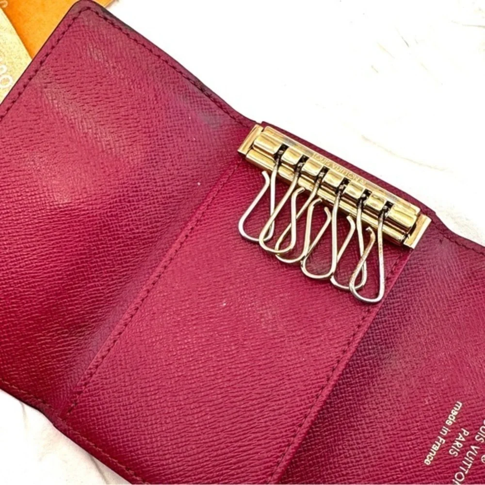 AUTHENTIC Louis Vuitton key holder. Monogram pattern. Magenta interior.
